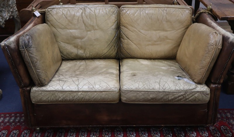 A small vintage two seater Knowle settee upholstered in studded pale brown leather, W.156cm, D.88cm, H.71cm